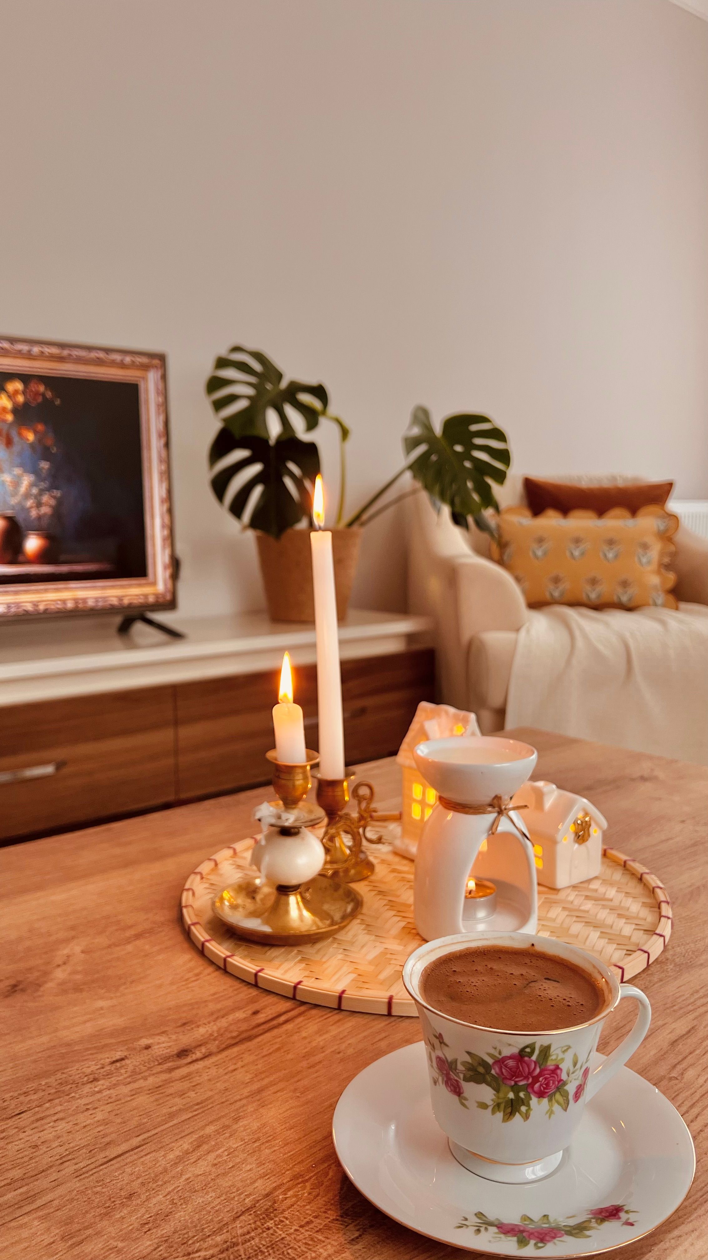 Free Warm living room setting with candles and coffee. Perfect for relaxation and cozy vibes. Stock Photo