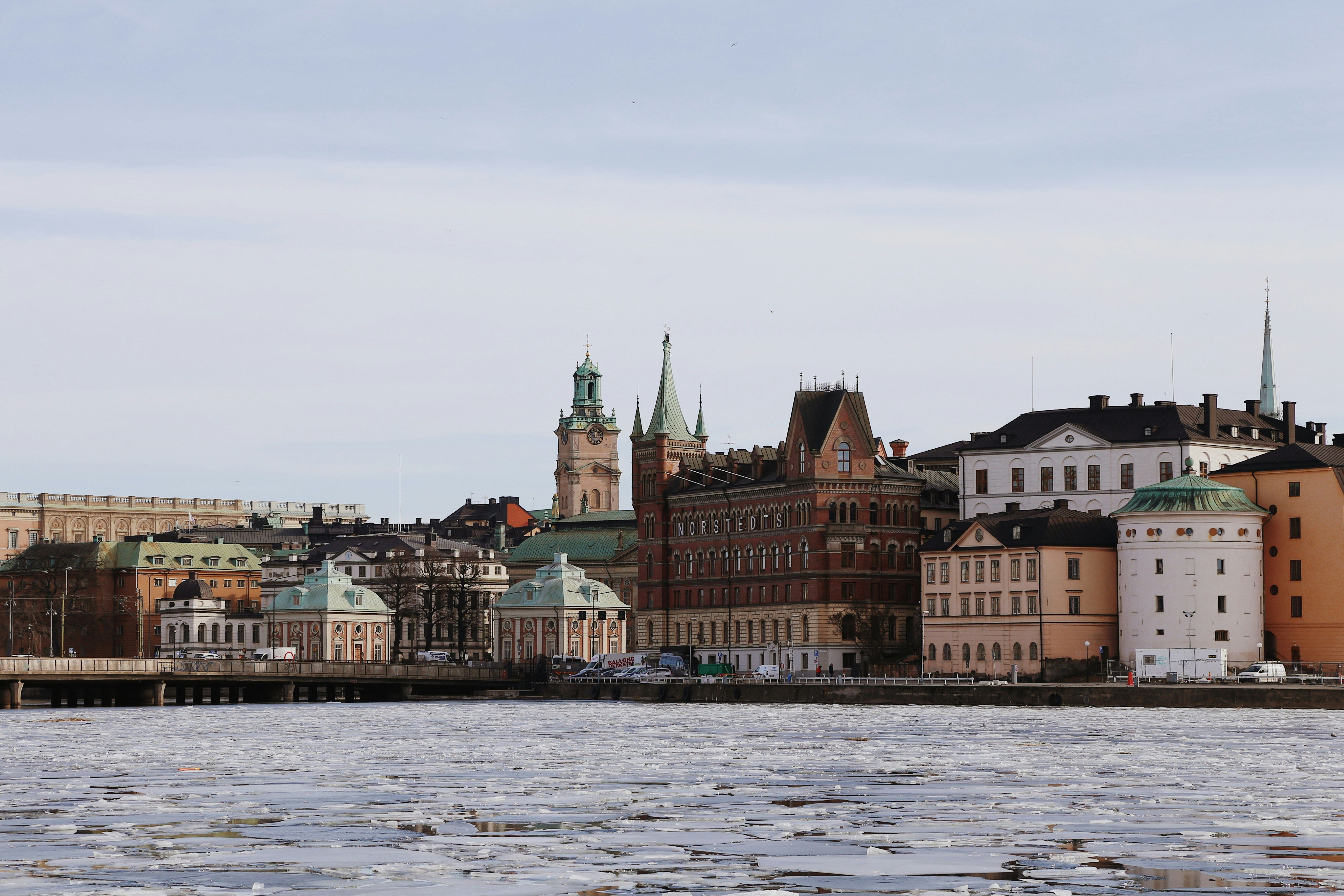 Ice on the water below the historic waterfront buildings of Stockholm