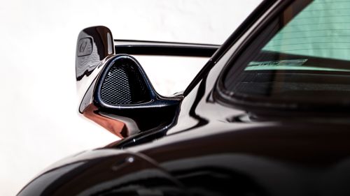 Free Detailed view of a luxury car's aerodynamic vent on a sleek black body. Stock Photo