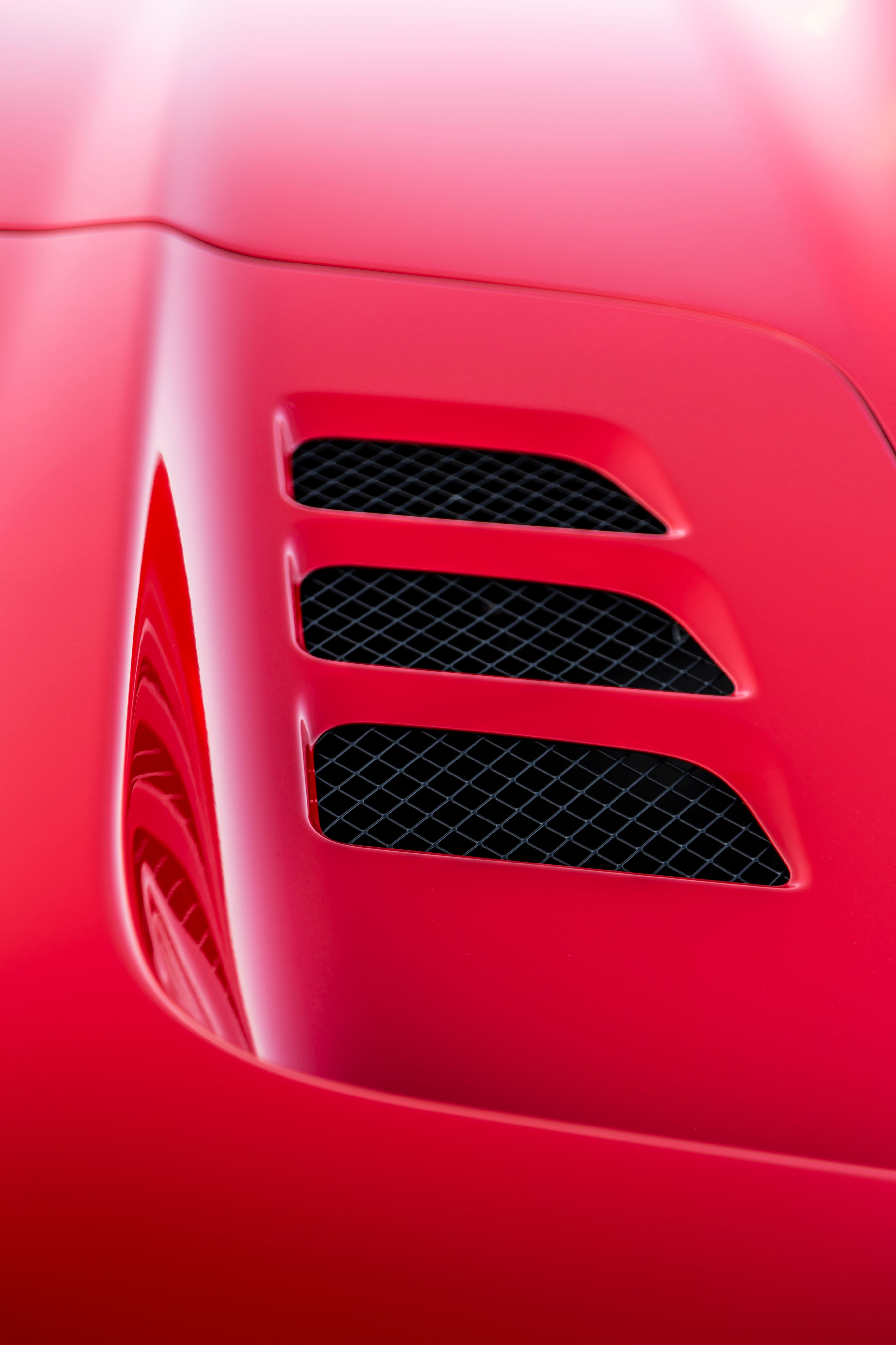 Close-Up of Red Supercar Air Vent Detail · Free Stock Photo