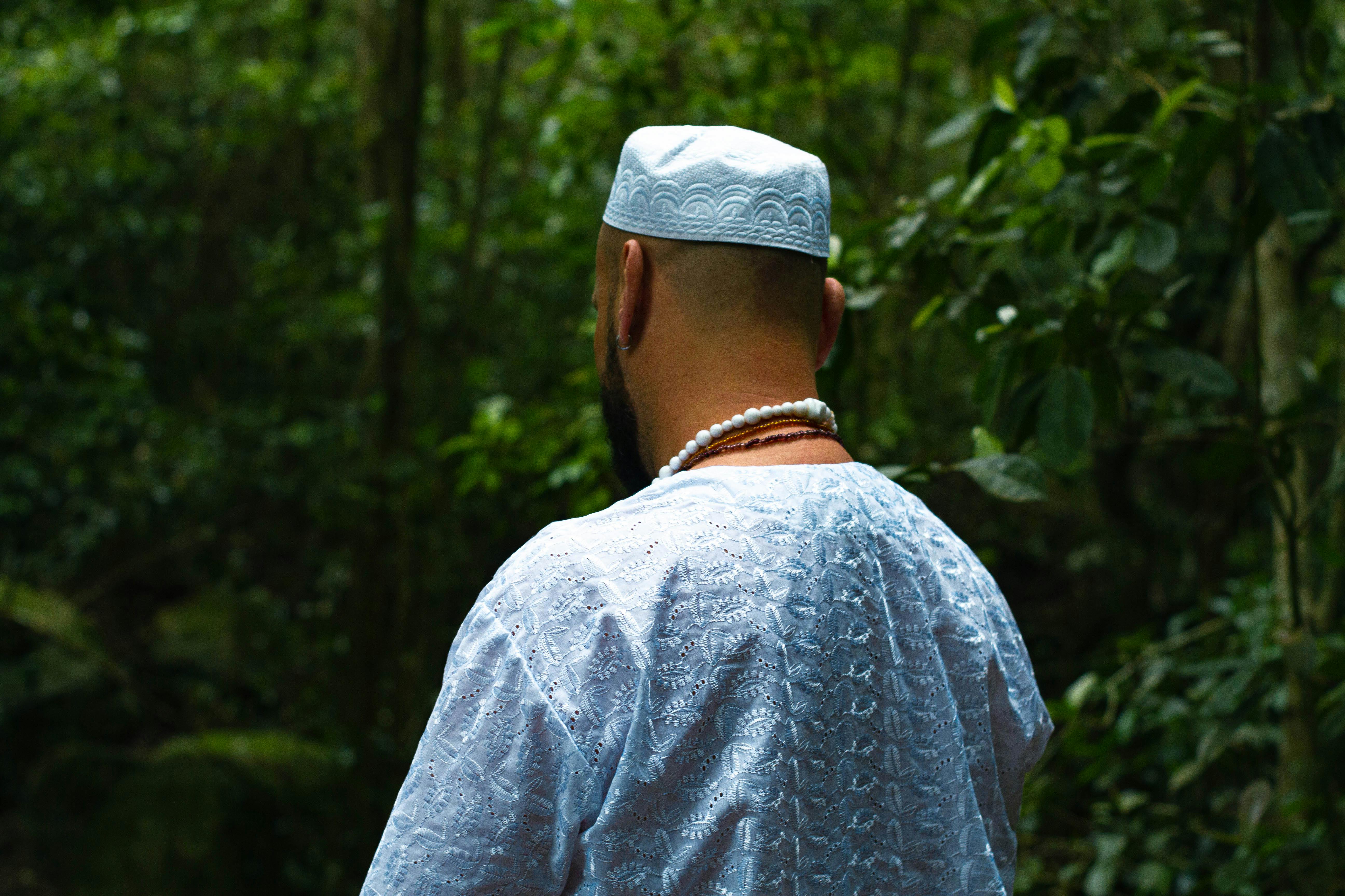 man in blue traditional garb in forest