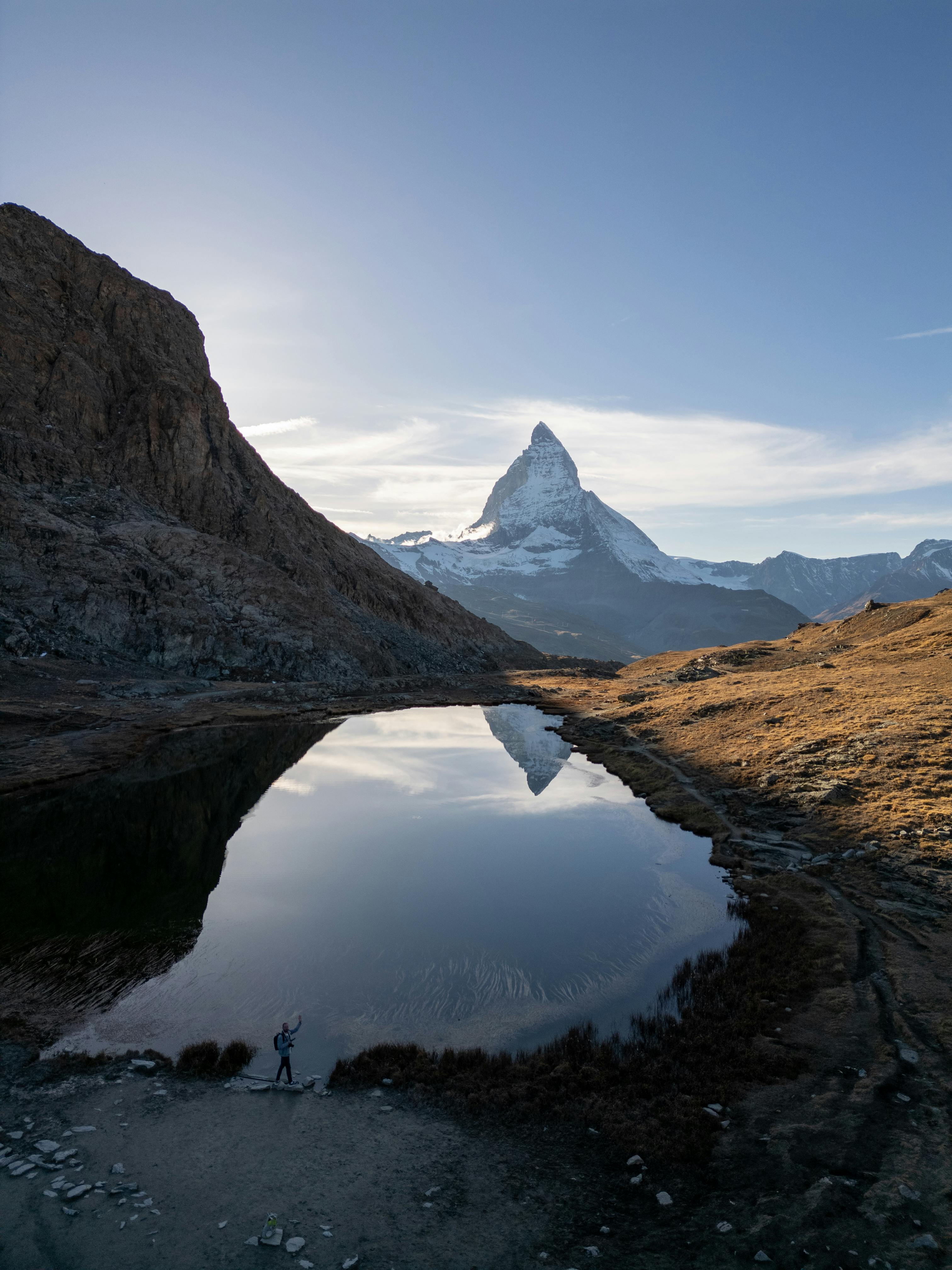 Scenic view of the Matterhorn reflected in a tranquil alpine lake in Zermatt, Switzerland.