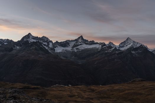 Breathtaking view of alpine mountains at sunrise in Zermatt, Switzerland.