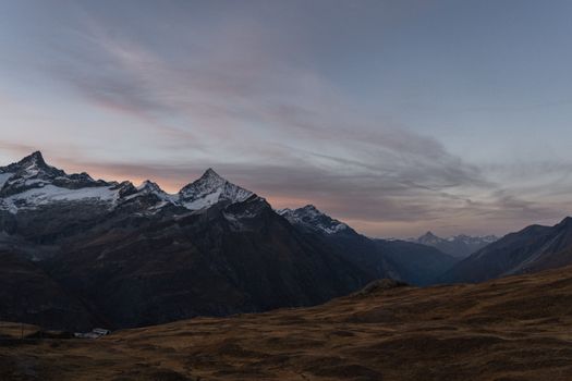 Captivating view of the Swiss Alps at sunset in Zermatt, Valais, Switzerland, showcasing serene mountain beauty.