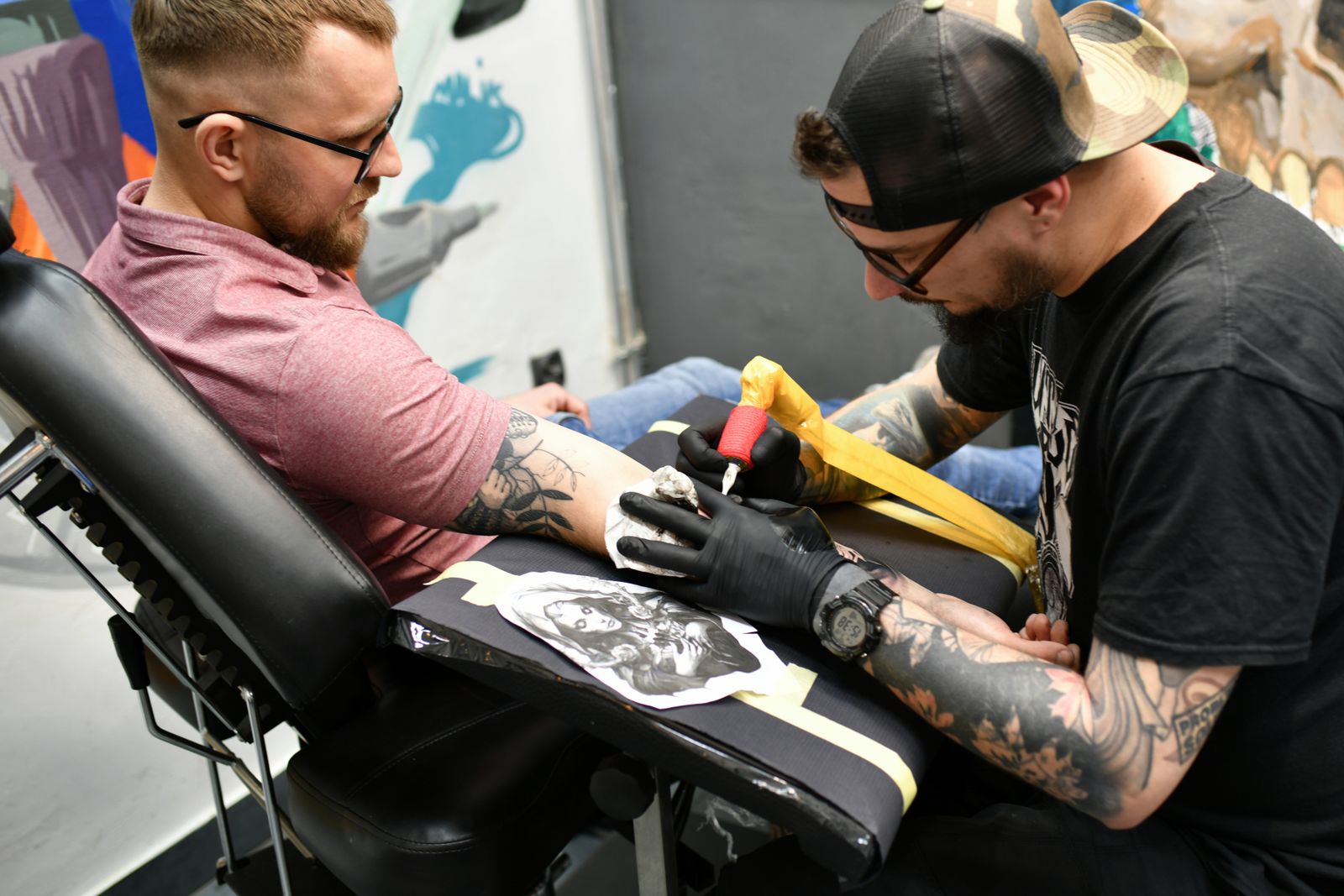 tattoo artist reviewing references during the tattoo artist consultation process
