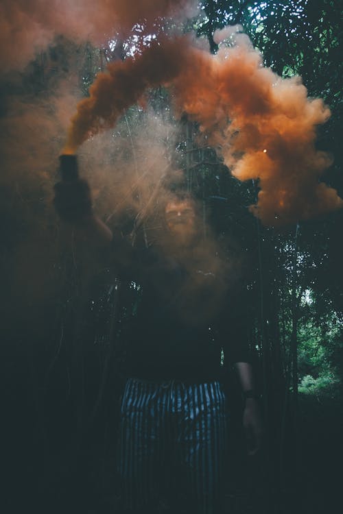 Photo Of Man Holding Smoke Bomb
