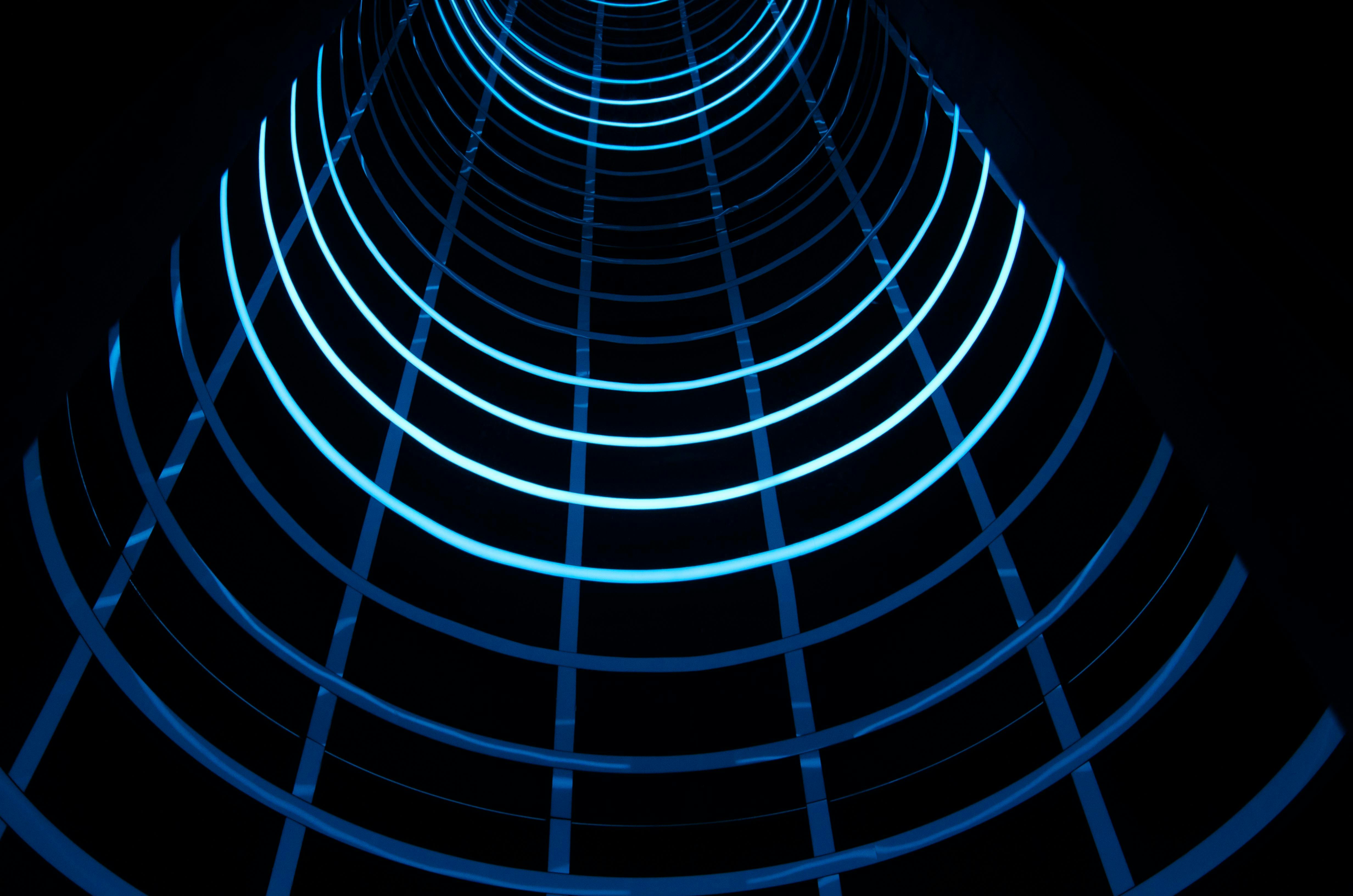 A mesmerizing abstract blue light tunnel with curved lines, creating a modern and futuristic look.