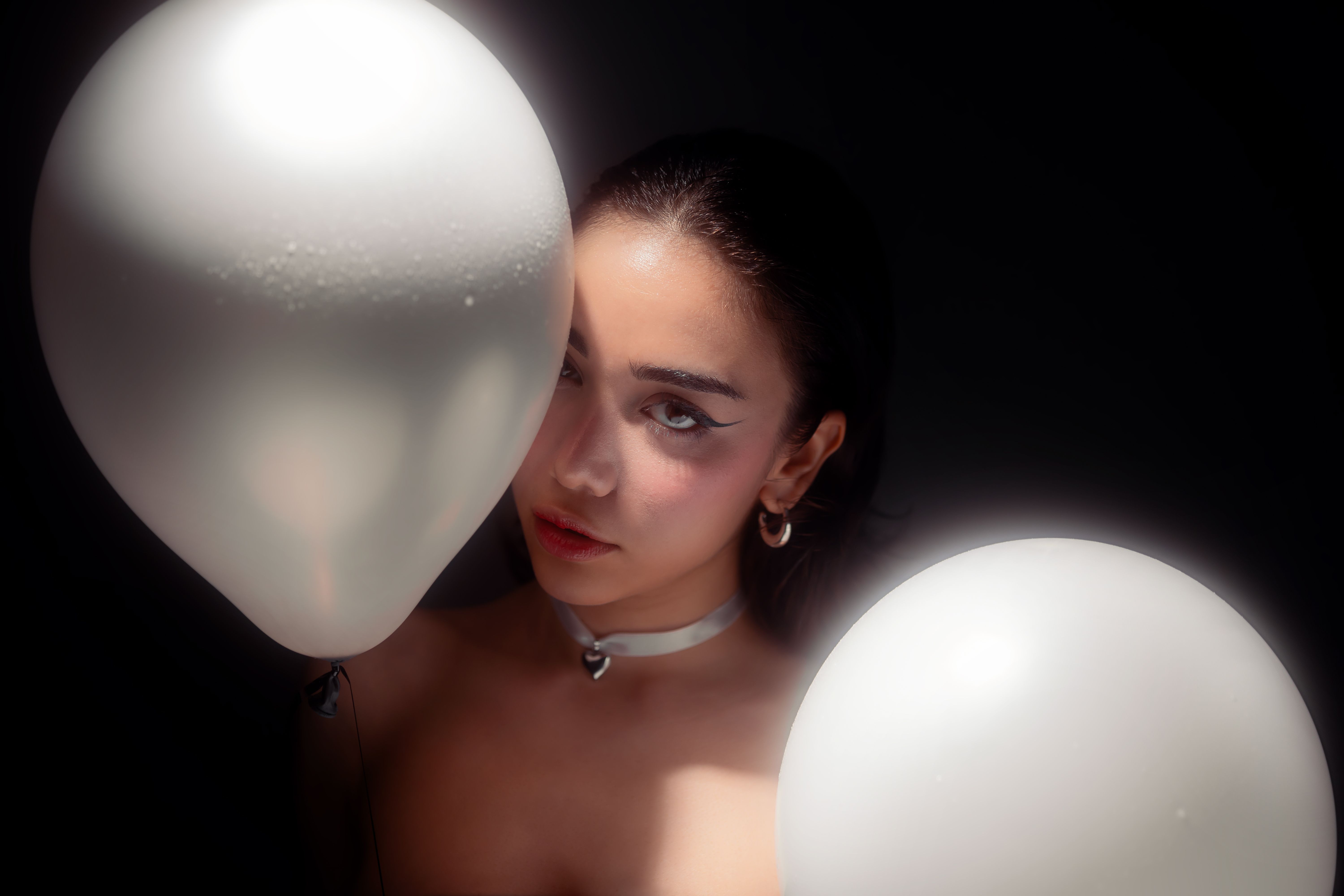 Artistic Portrait with Balloons and Dramatic Lighting · Free Stock Photo