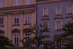 Historic European architecture with vibrant cafes at twilight.