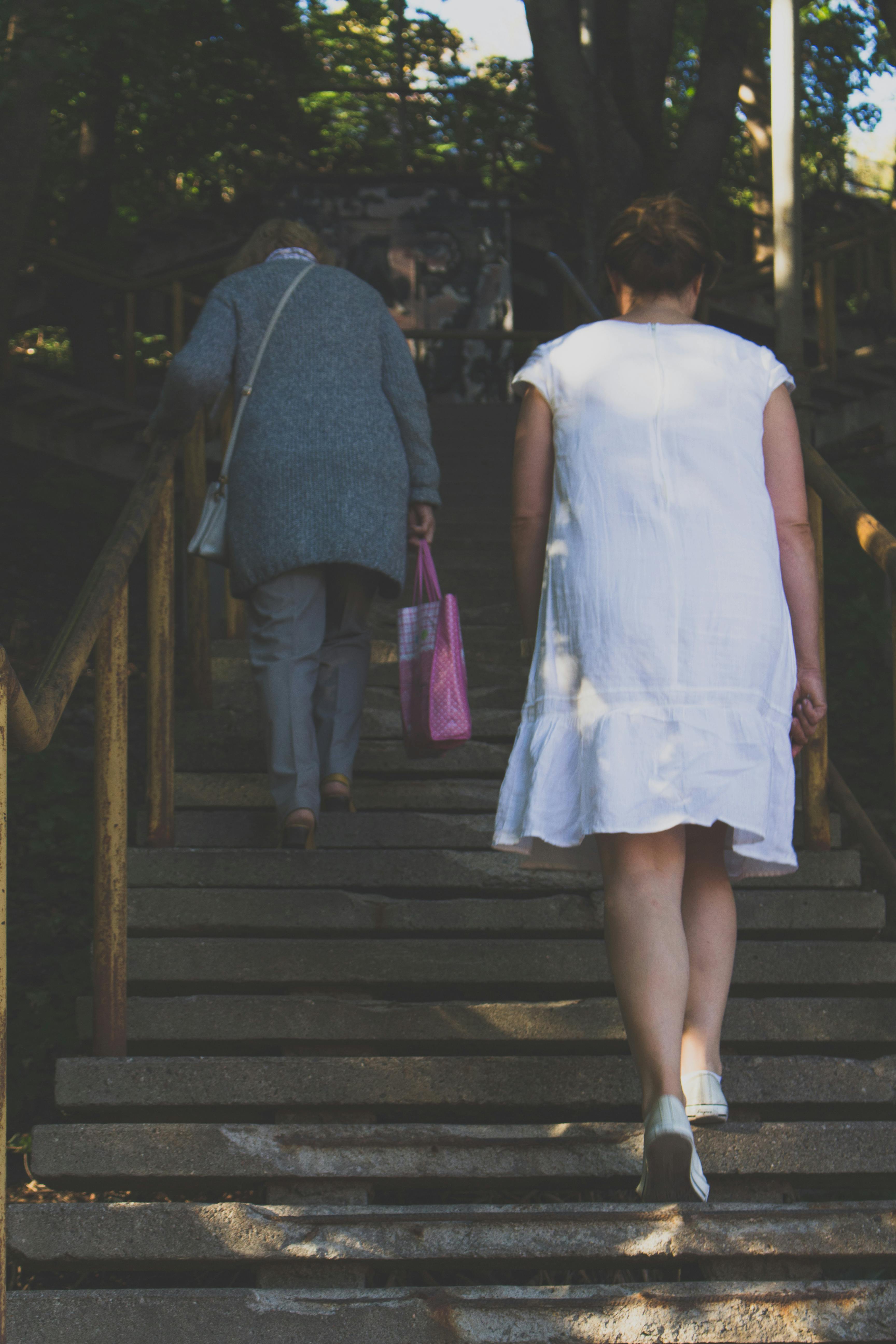 Woman in White Dress Climbing the Stairs · Free Stock Photo