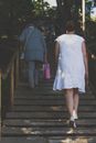Woman in White Dress Climbing the Stairs
