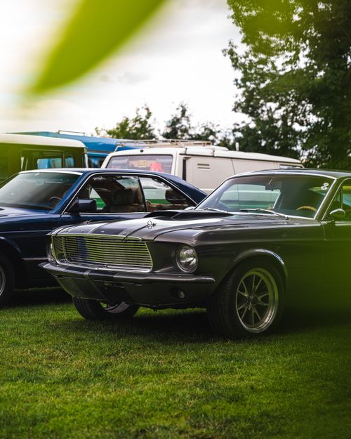 Free Vintage Ford Mustang parked outdoors, showcasing its classic appeal. Stock Photo