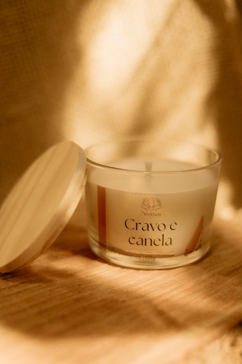 Free A cozy scented candle with clove and cinnamon aroma in warm ambient light. Stock Photo
