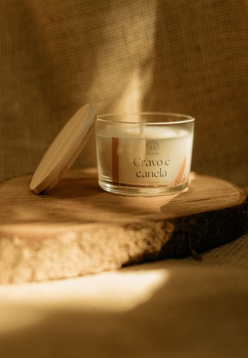Free A rustic candle in glass on wooden slab with warm sunlight. Stock Photo