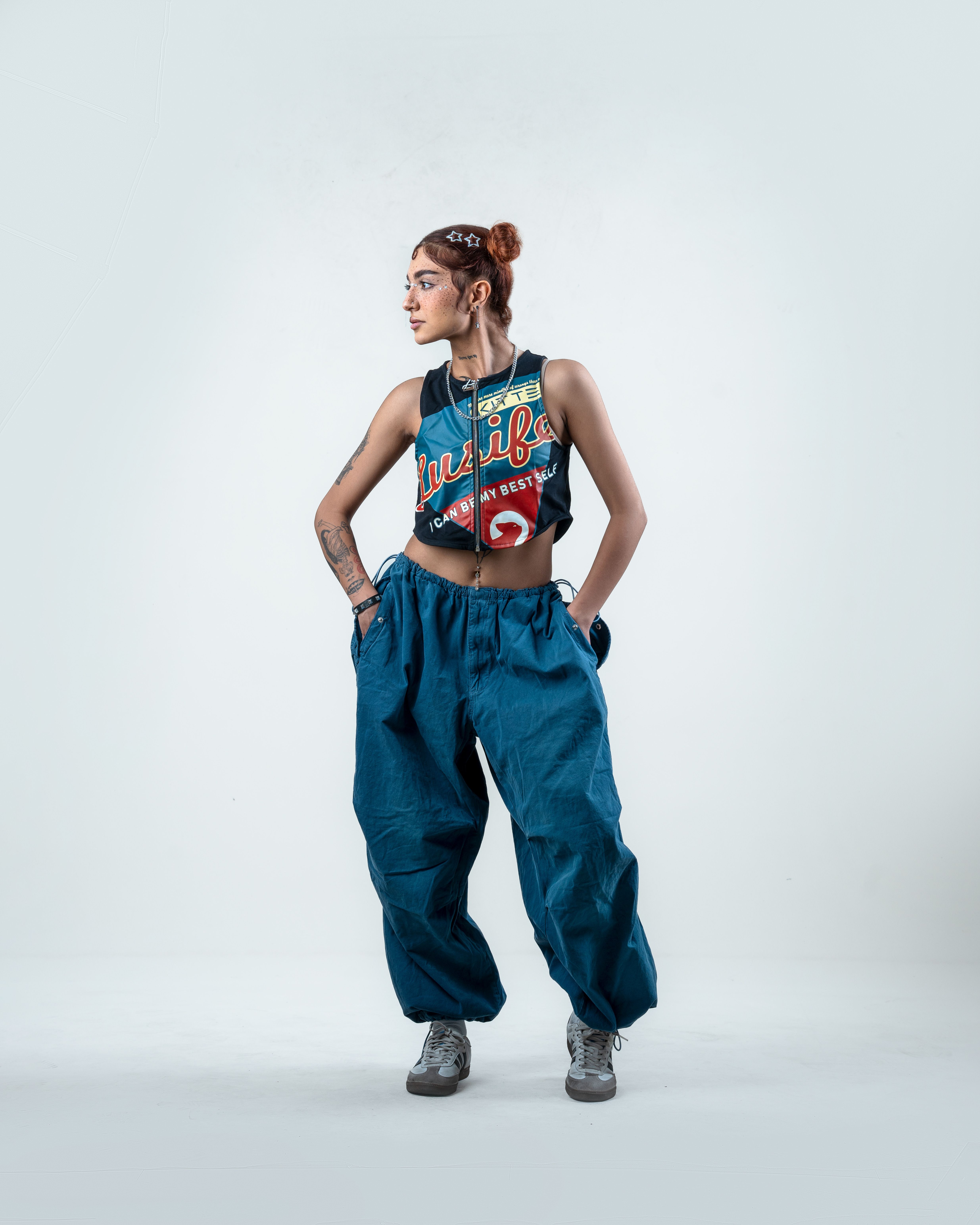 woman wearing tank top and parachute pants casual