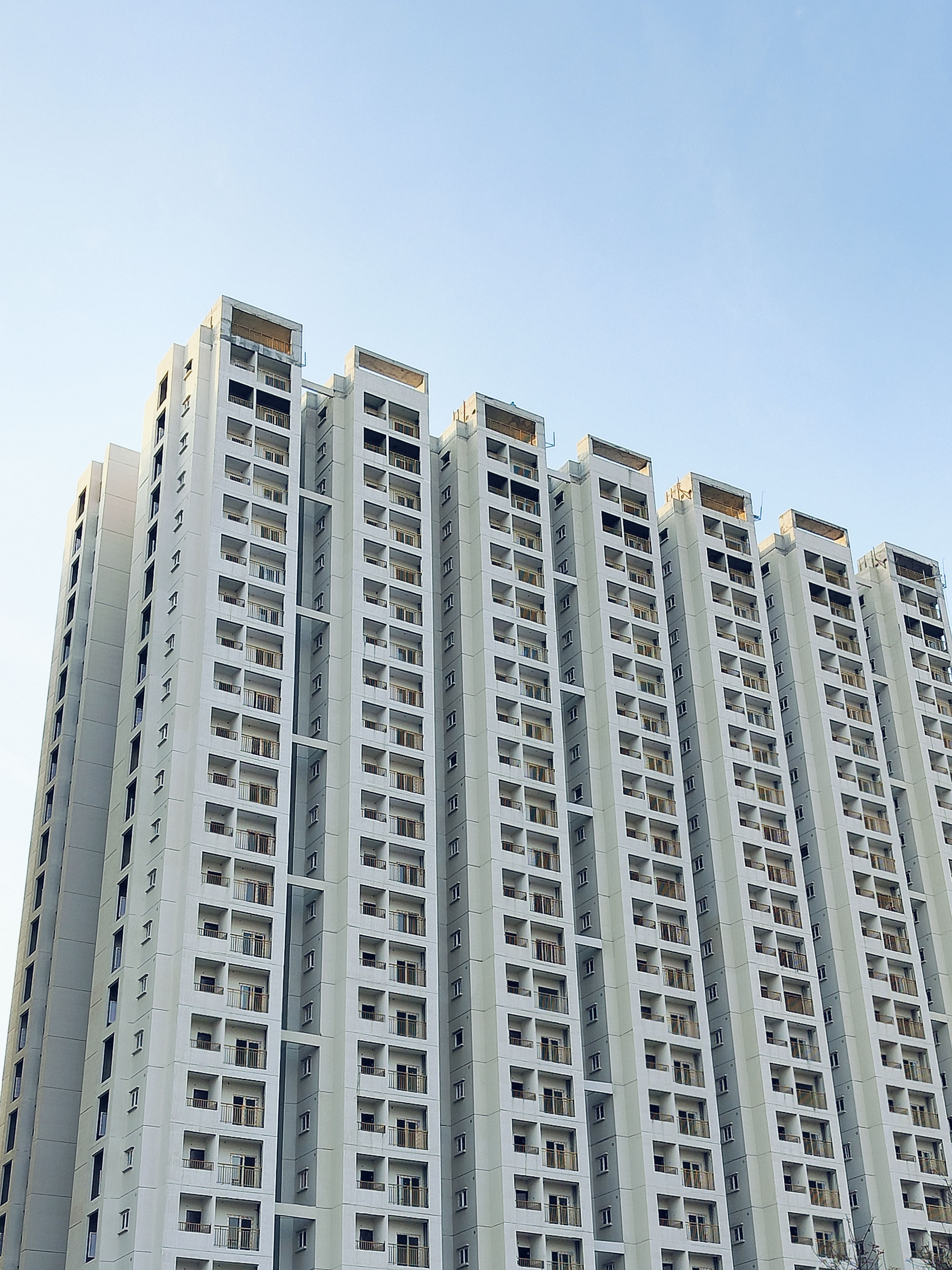 Modern High-Rise Building Under Clear Blue Sky · Free Stock Photo