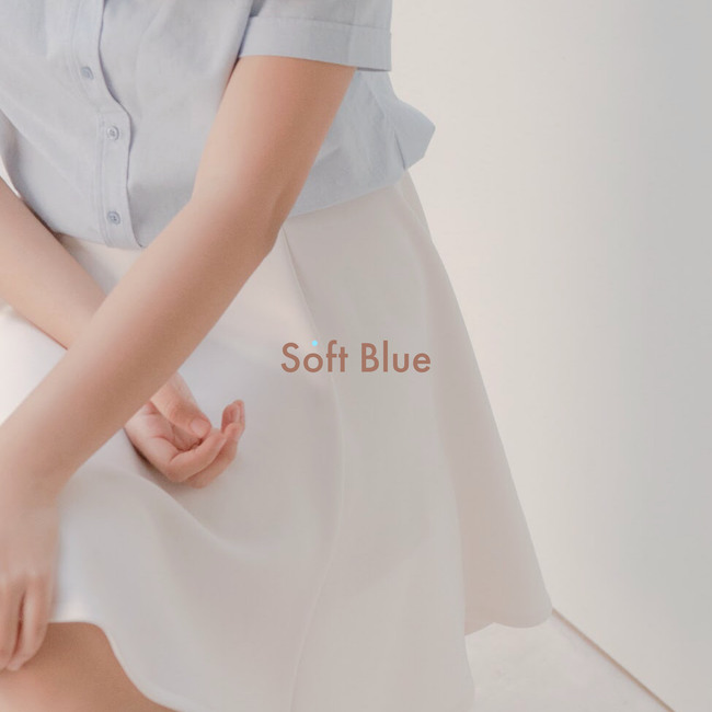 Stylish close-up of a woman's outfit featuring soft blue and white fashion elements.