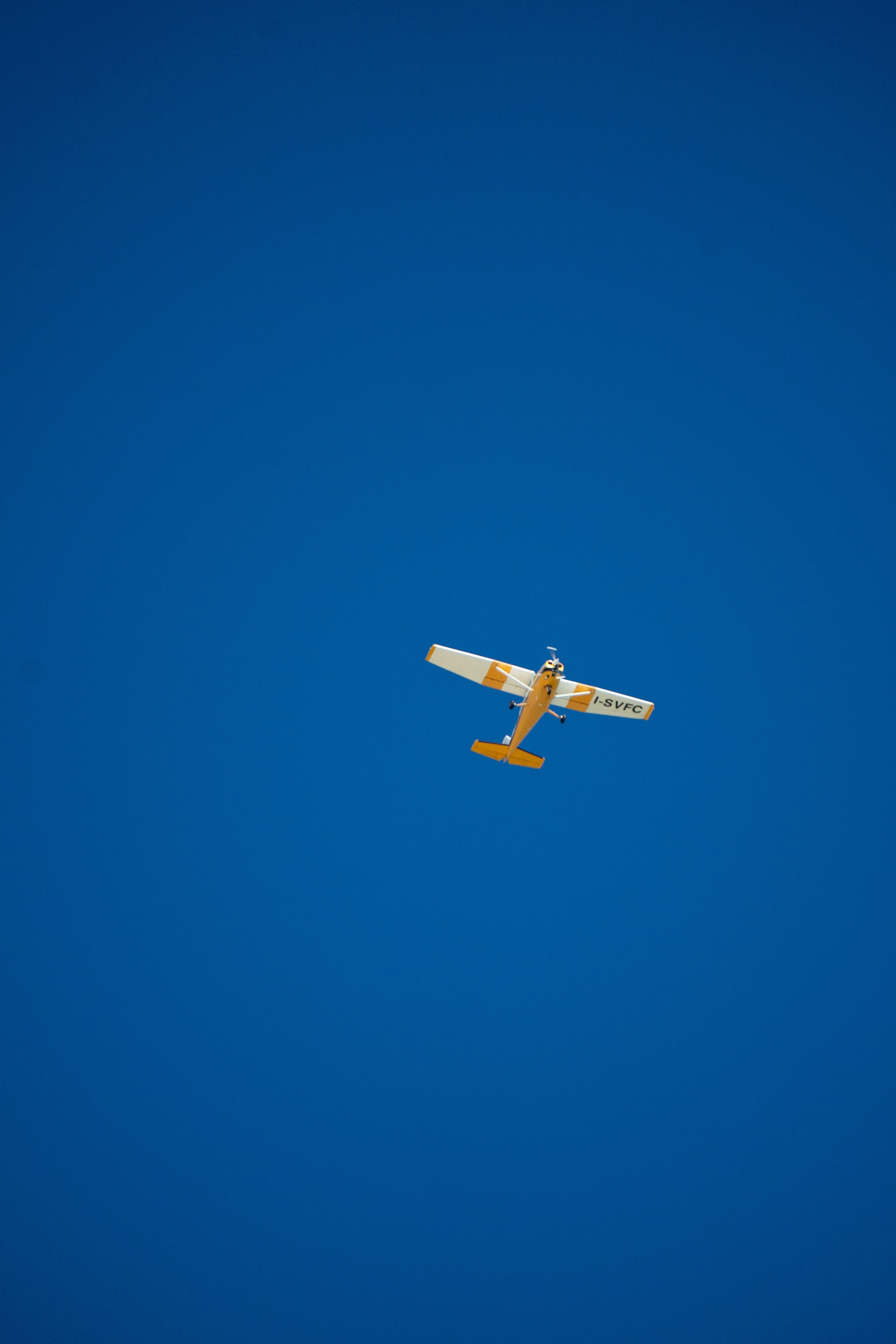 Small Airplane Flying in Clear Blue Sky · Free Stock Photo