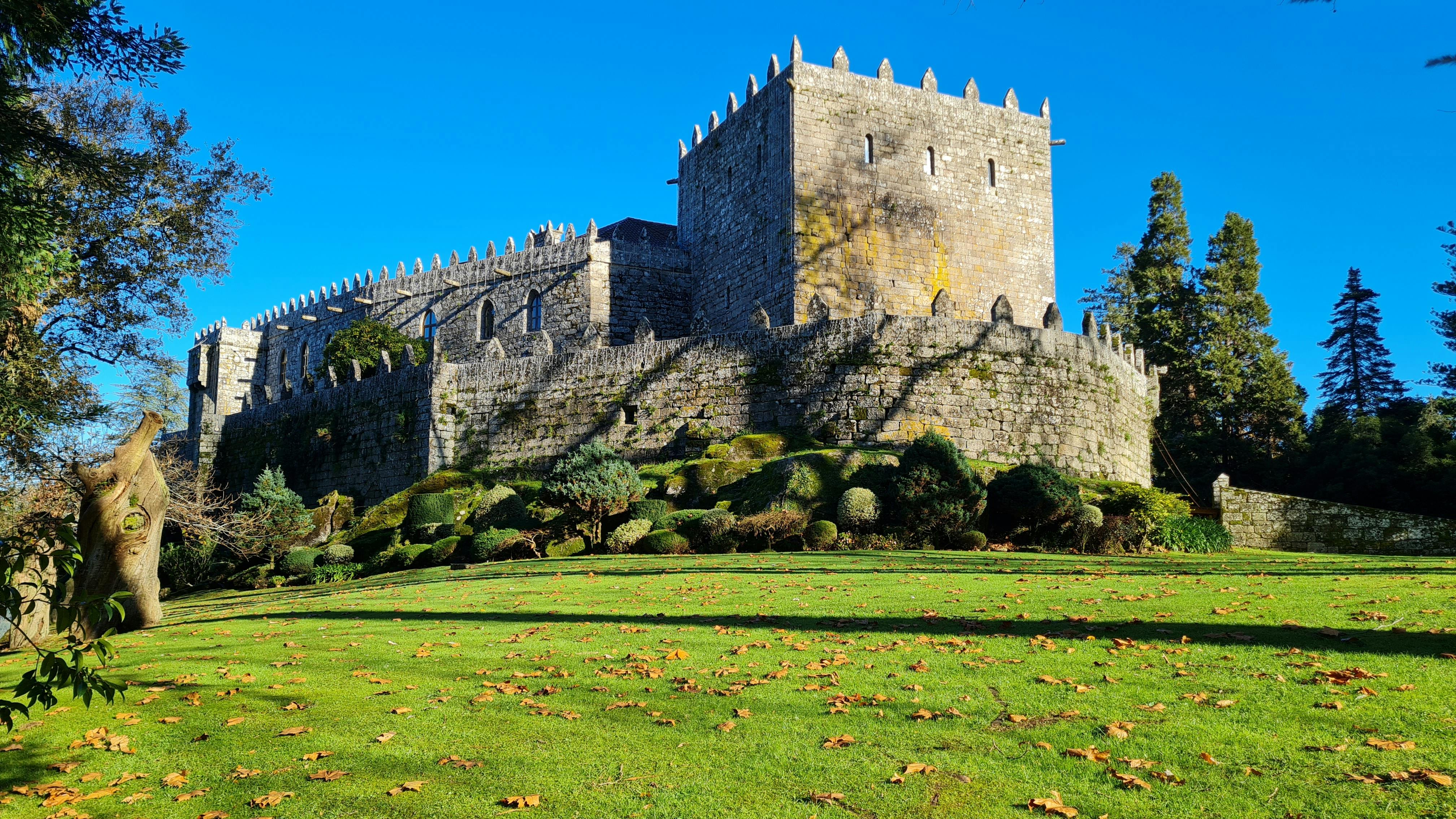 medieval stone castle with lush green garden