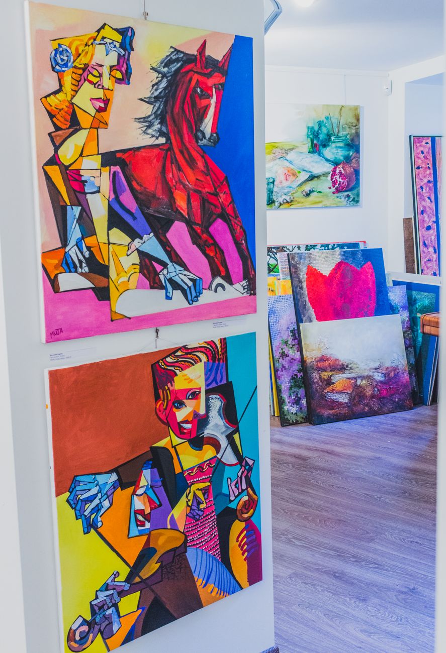 Explore vibrant abstract artworks featured in a well-lit, colorful art gallery.