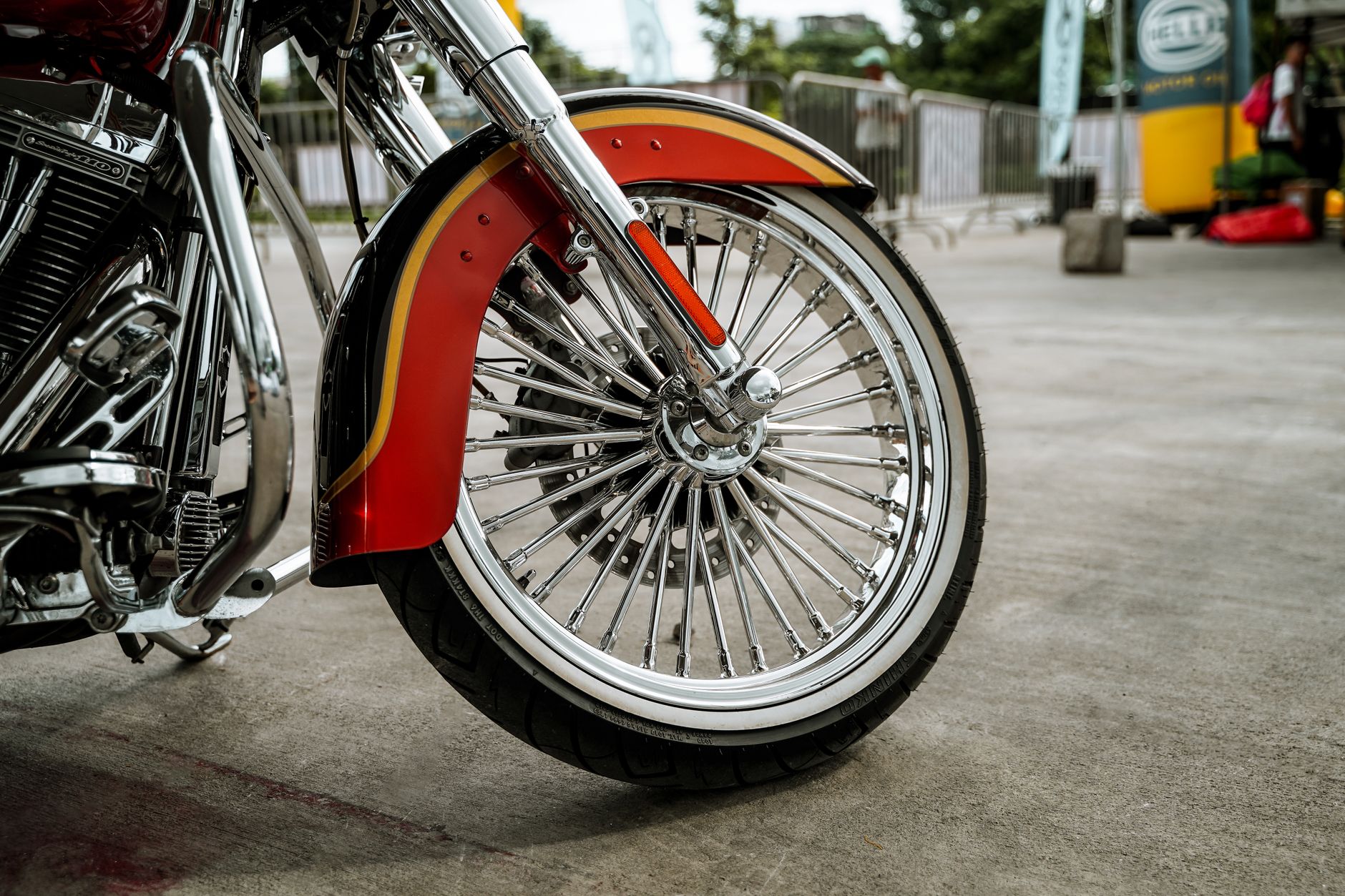 Close-up of a chrome motorcycle wheel and tire tread showing wear detail