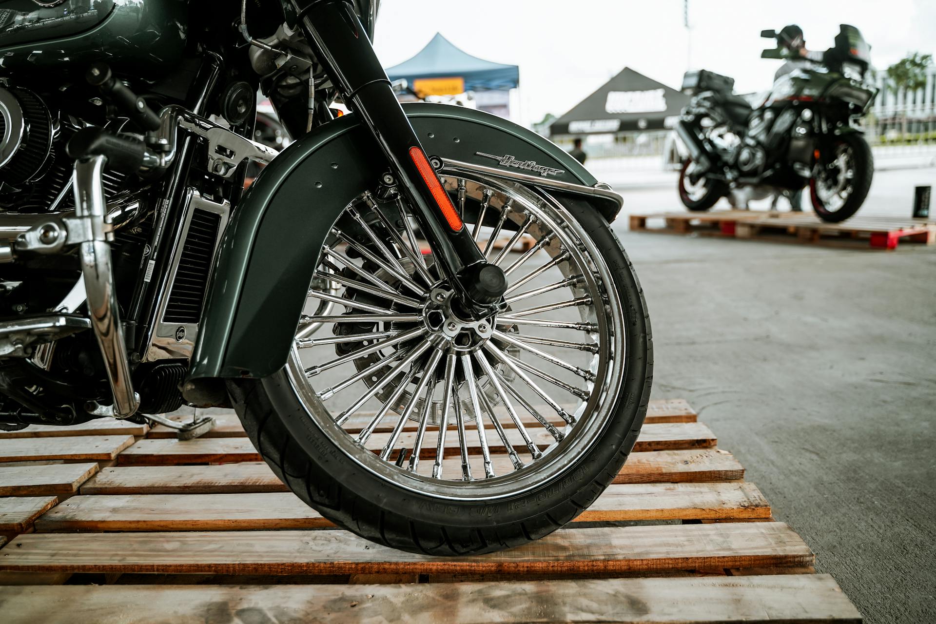 Detailed close-up of a motorcycle wheel on a pallet in Quezon City, Philippines.