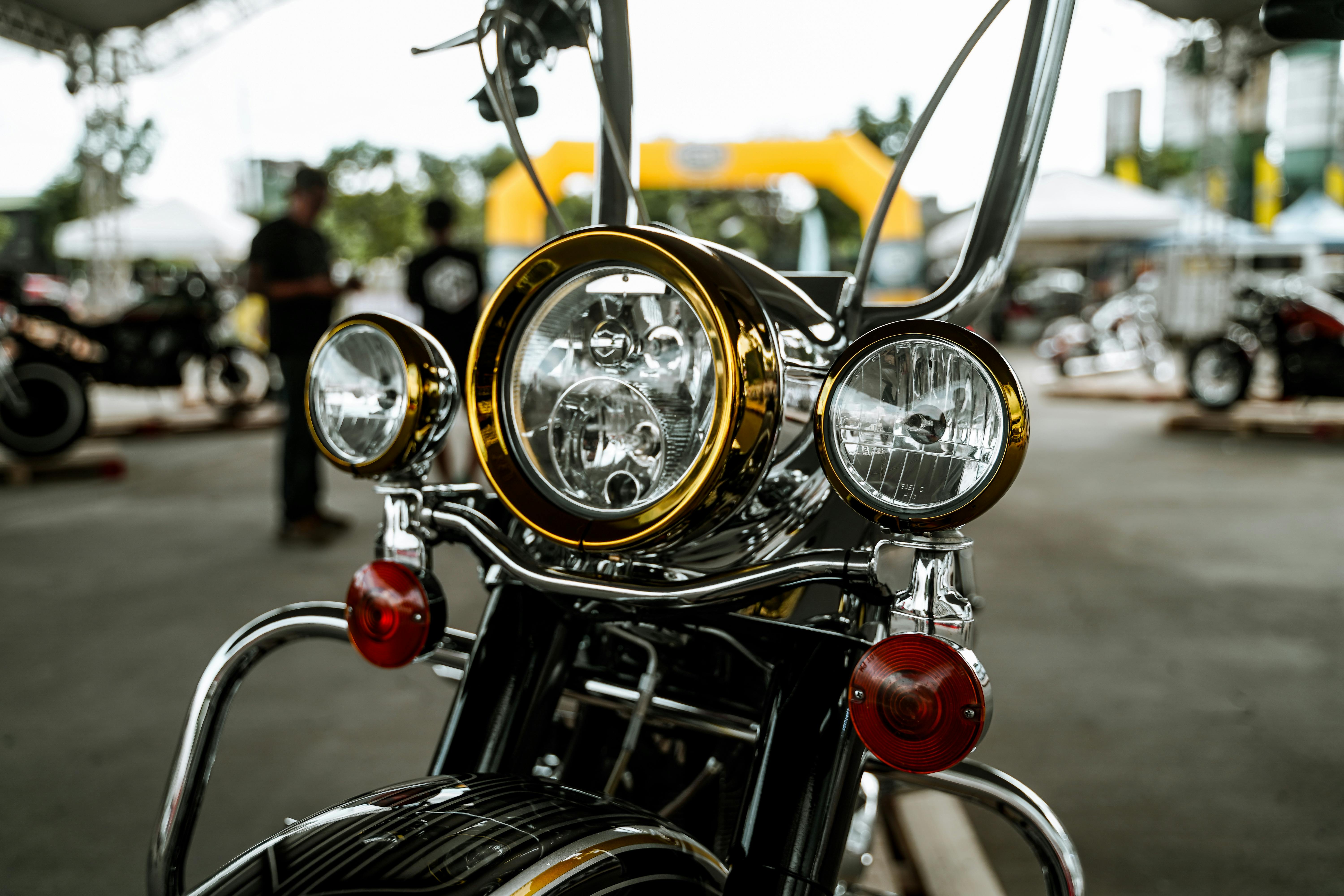 Close-up of vintage motorcycle headlight at an outdoor event in Quezon City, Philippines.