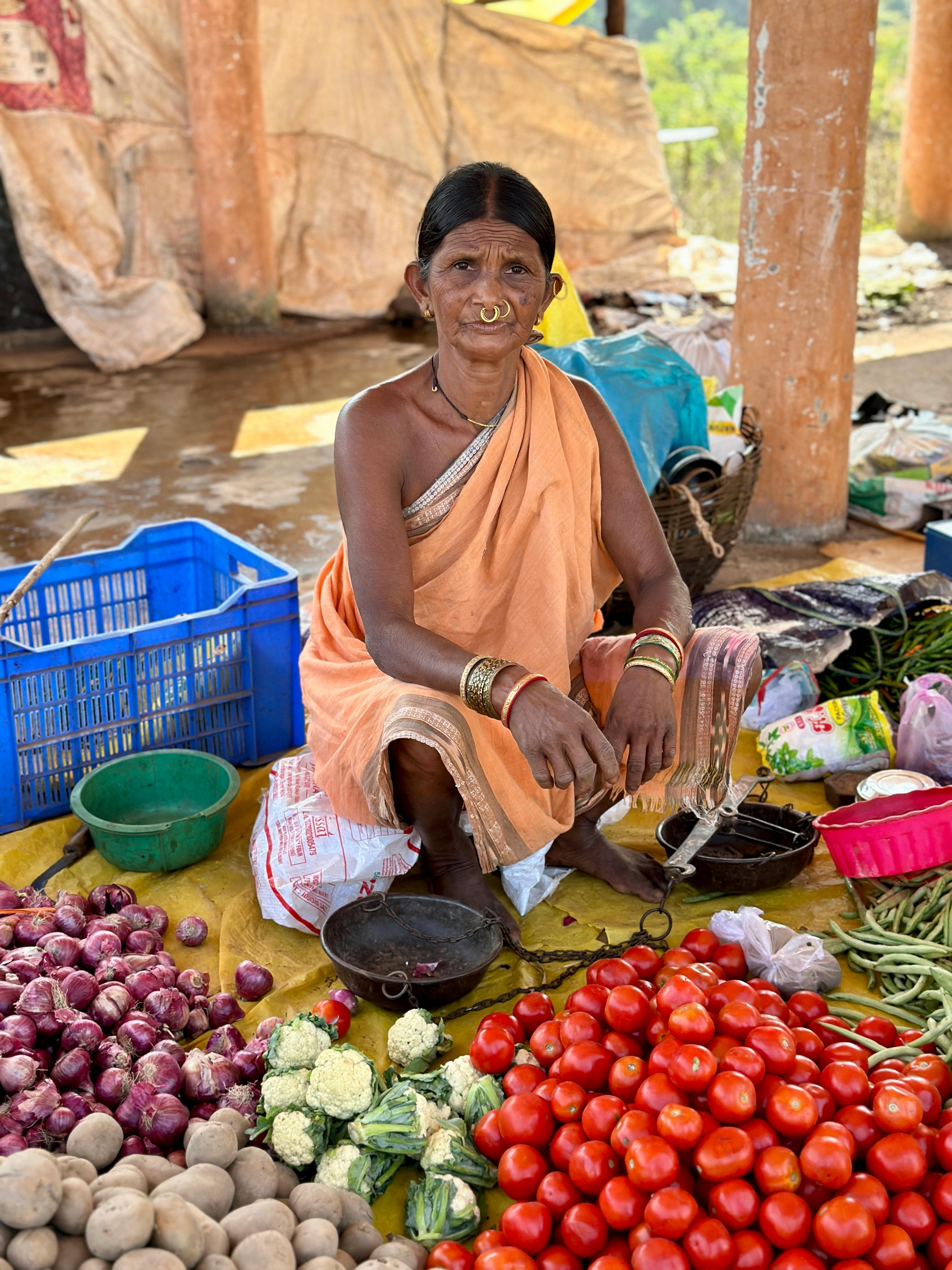 tribal woman selling vegetables in indian market