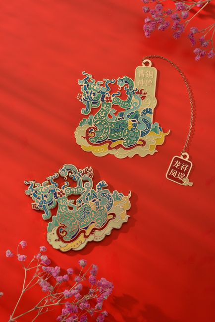Elegant Chinese dragon ornaments displayed against a vibrant red background, adorned with delicate floral accents.