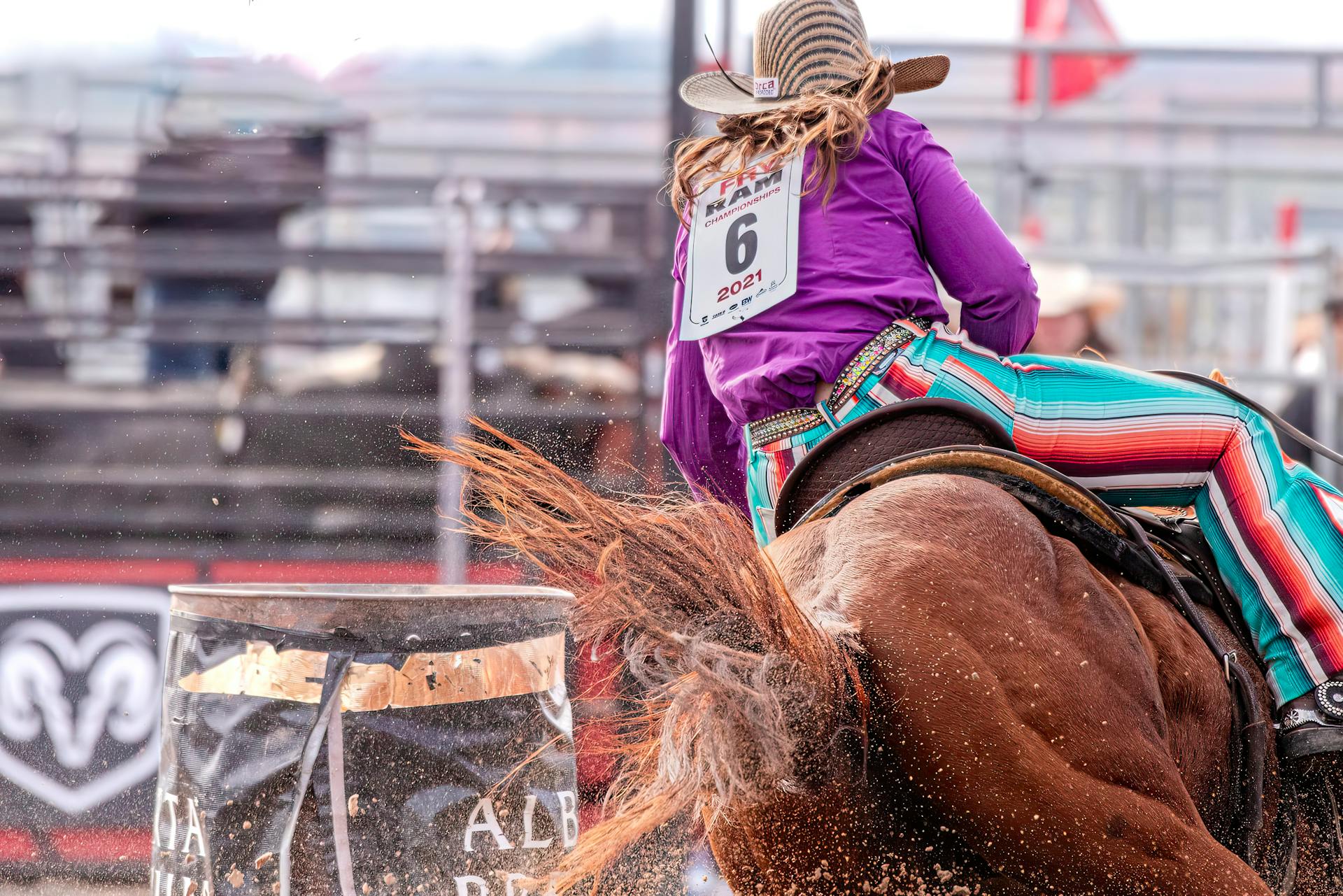 Action-packed shot of a cowboy turning a barrel during a thrilling rodeo event.