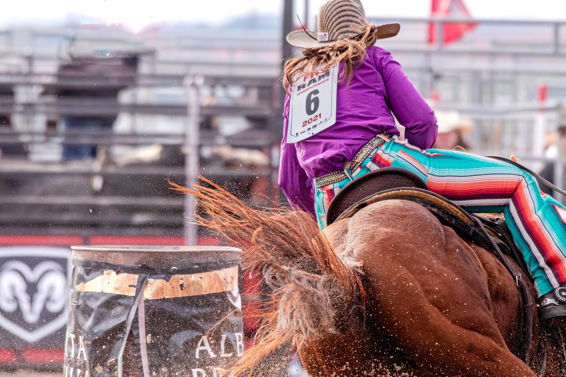 Dynamic Barrel Racing at a Rodeo Event · Free Stock Photo