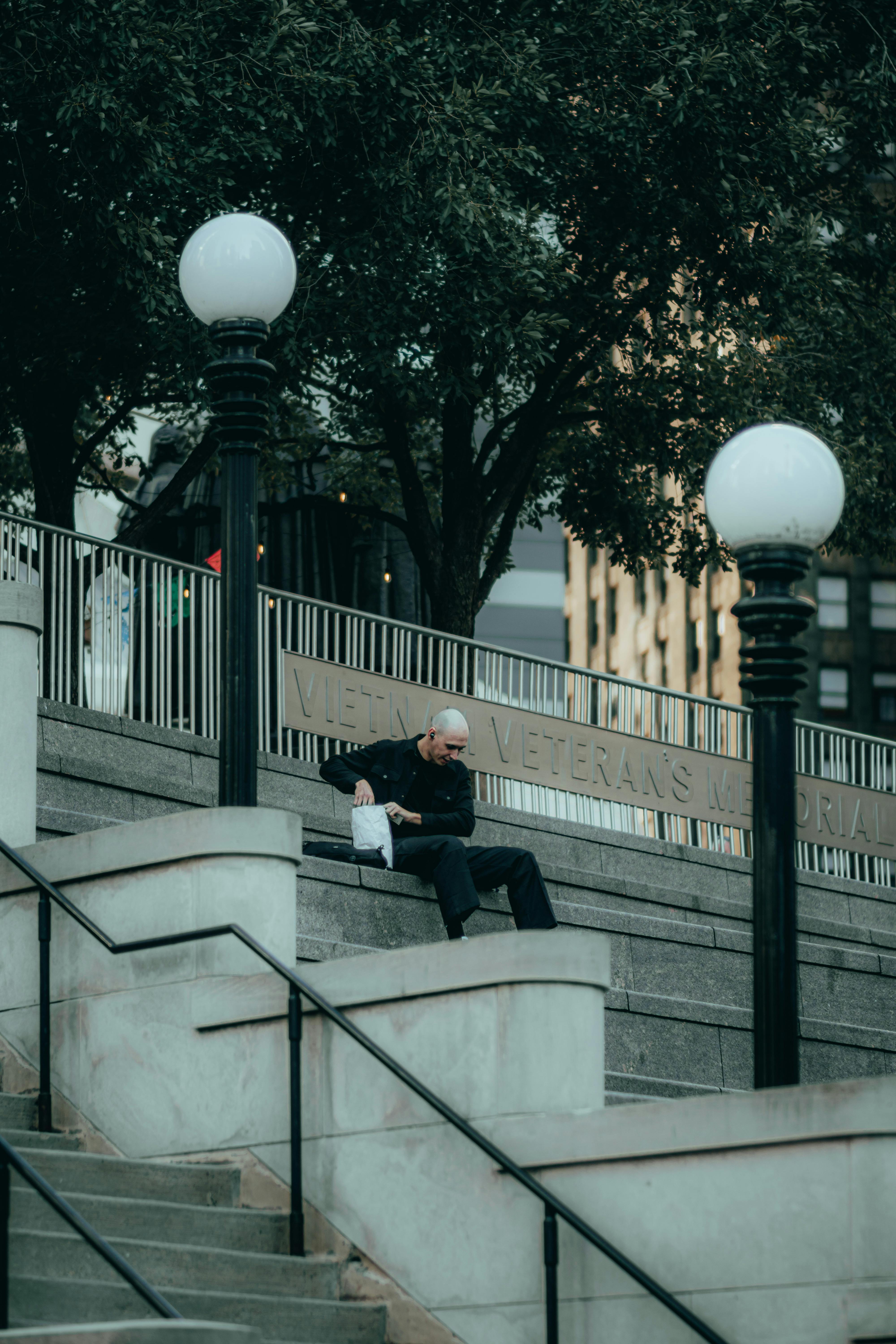man relaxing on steps at chicago veterans memorial