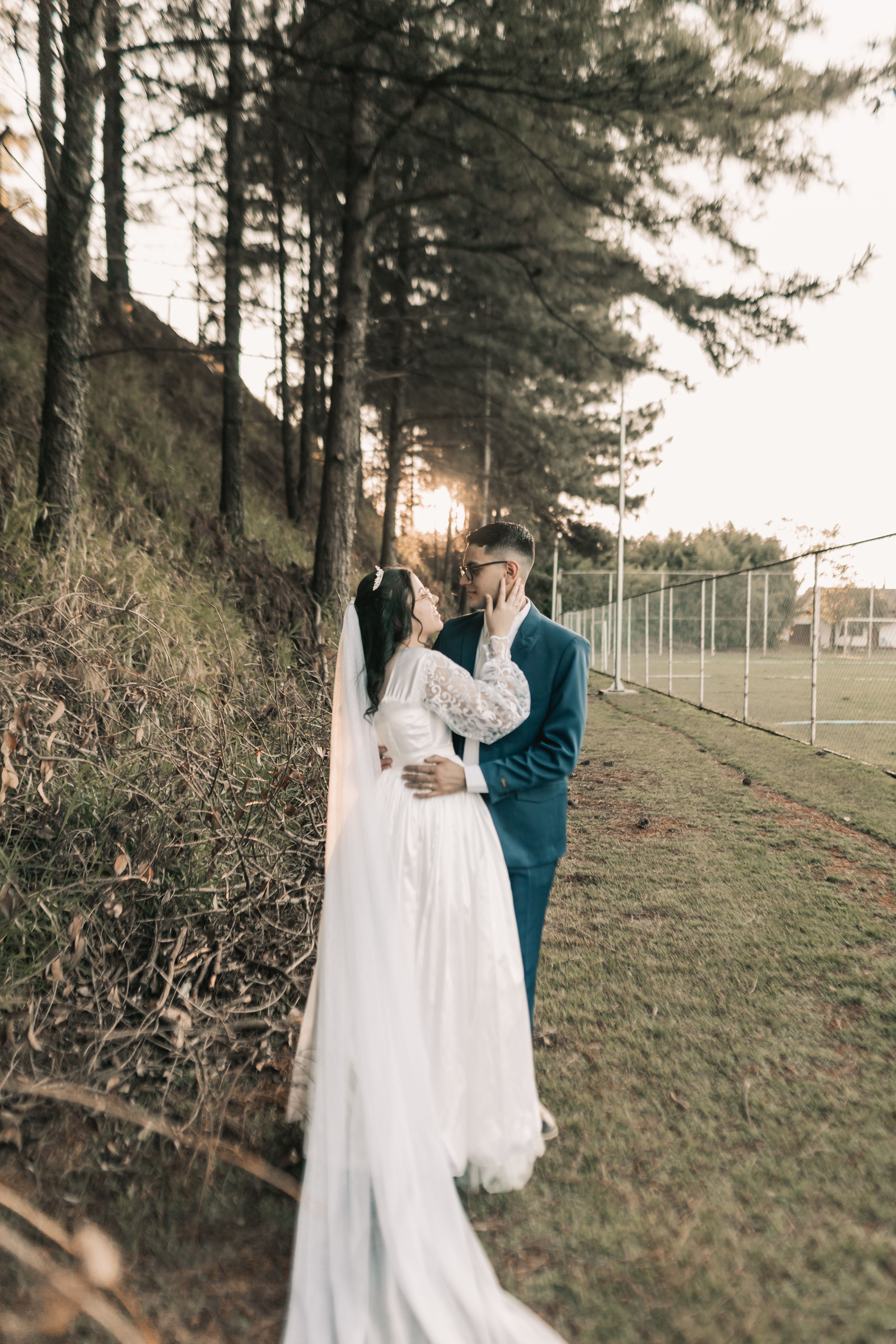 Romantic Wedding Couple Embracing Outdoors · Free Stock Photo