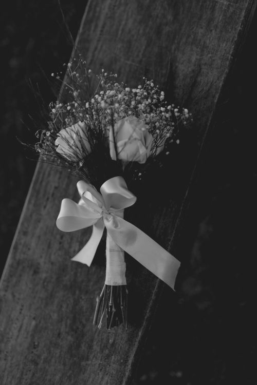 Free A classic black and white photograph of a bridal bouquet on wooden plank. Stock Photo