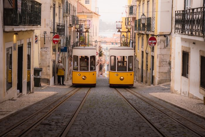 Yellow trams on a cobbled old-town street — photo by Naimish Verma on Pexels