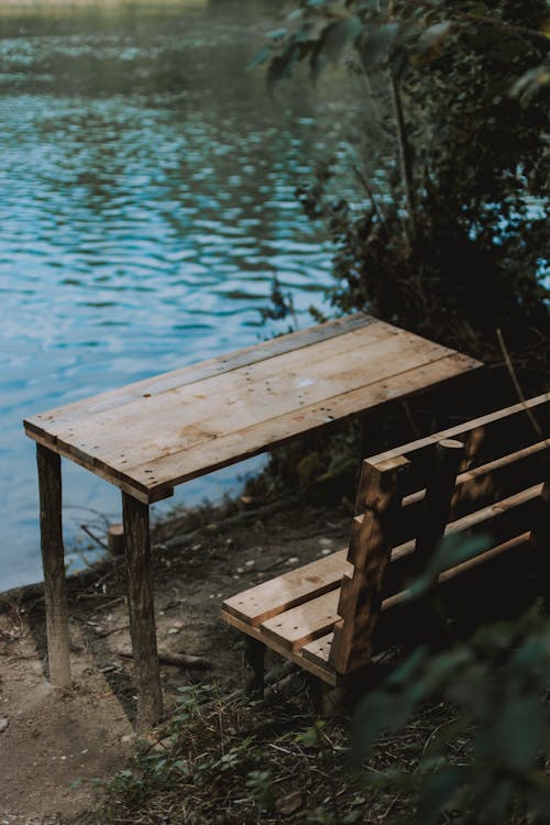 Free Bench and table on lake shore Stock Photo