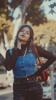 Fashionable young woman posing confidently on a city street in Puebla, Mexico.