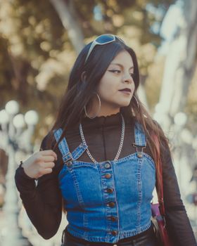 Young woman in fashionable denim outfit captured on a street in Puebla.