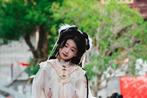 Free Charming young girl in traditional costume posing outdoors with vibrant greenery in the background. Stock Photo