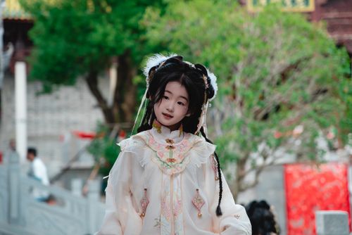 Free Beautiful portrait of a young girl in traditional Asian dress outdoors, surrounded by historic architecture. Stock Photo