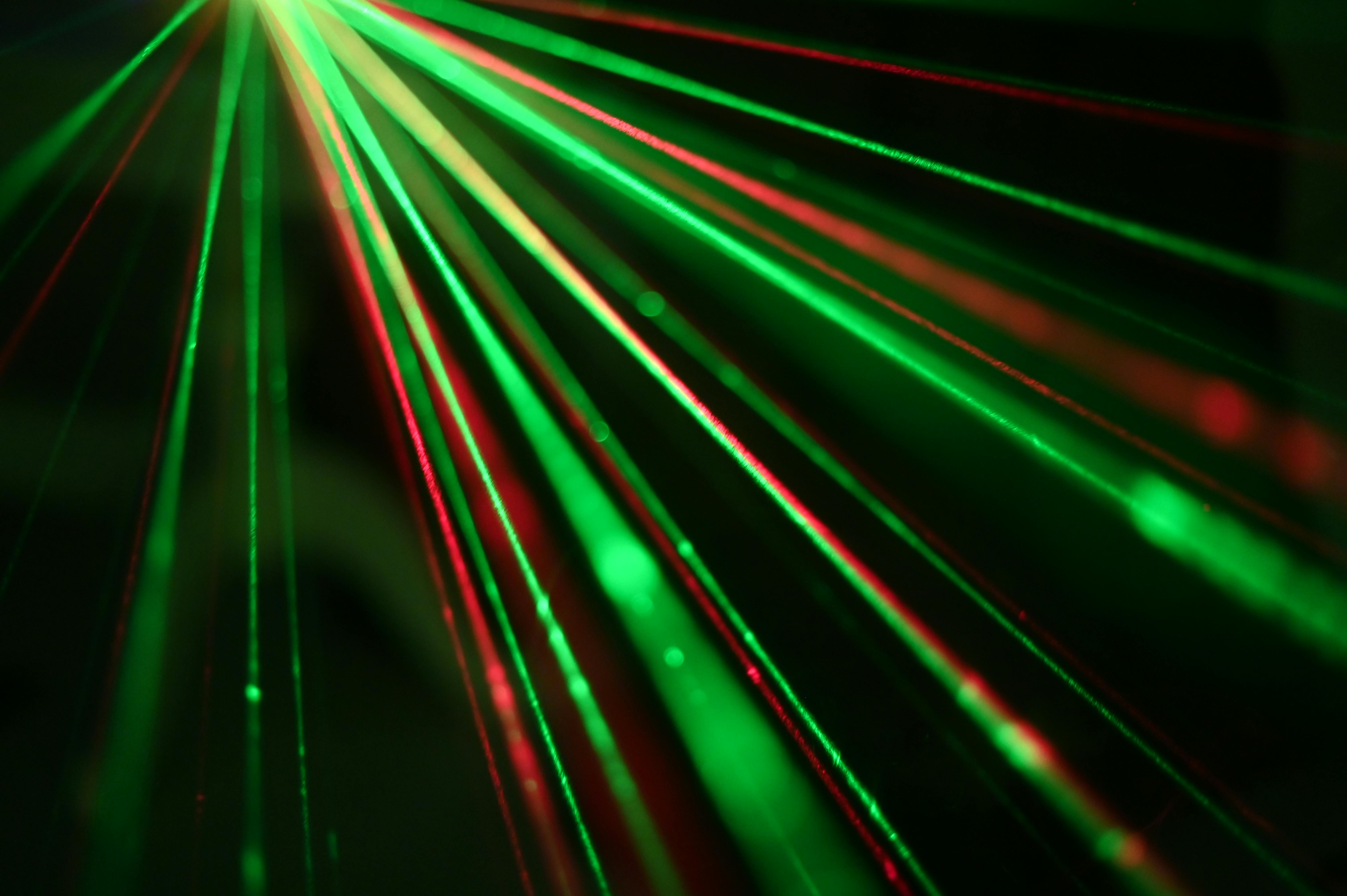 Vibrant display of red and green laser light beams creating dynamic patterns.