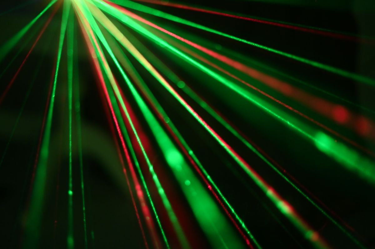 Professional red and green laser show beams in a live production
