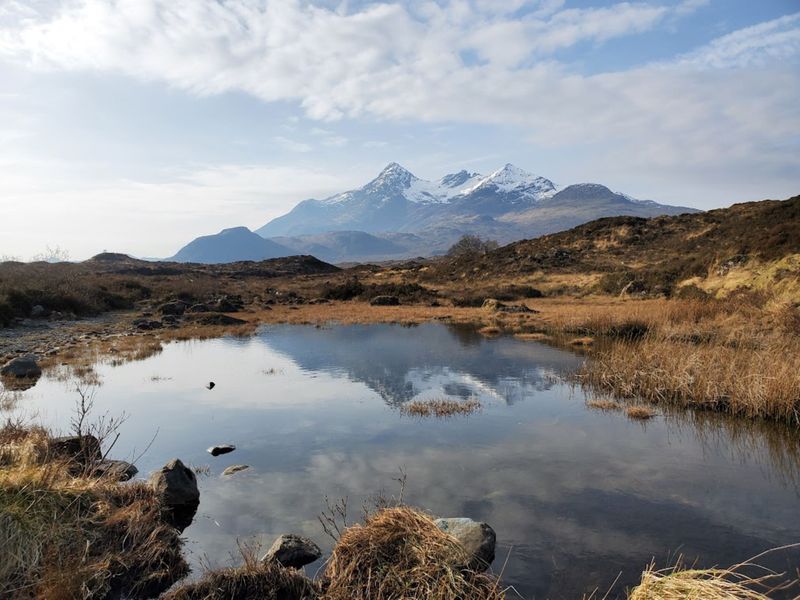 Serene Highland loch reflecting snow-capped mountains near Aberdeen