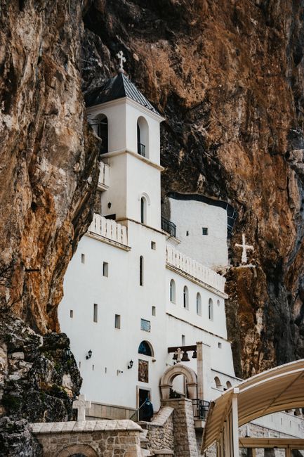 A stunning monastery built into the rock face in Dabovići, Montenegro, showcasing historical architecture.