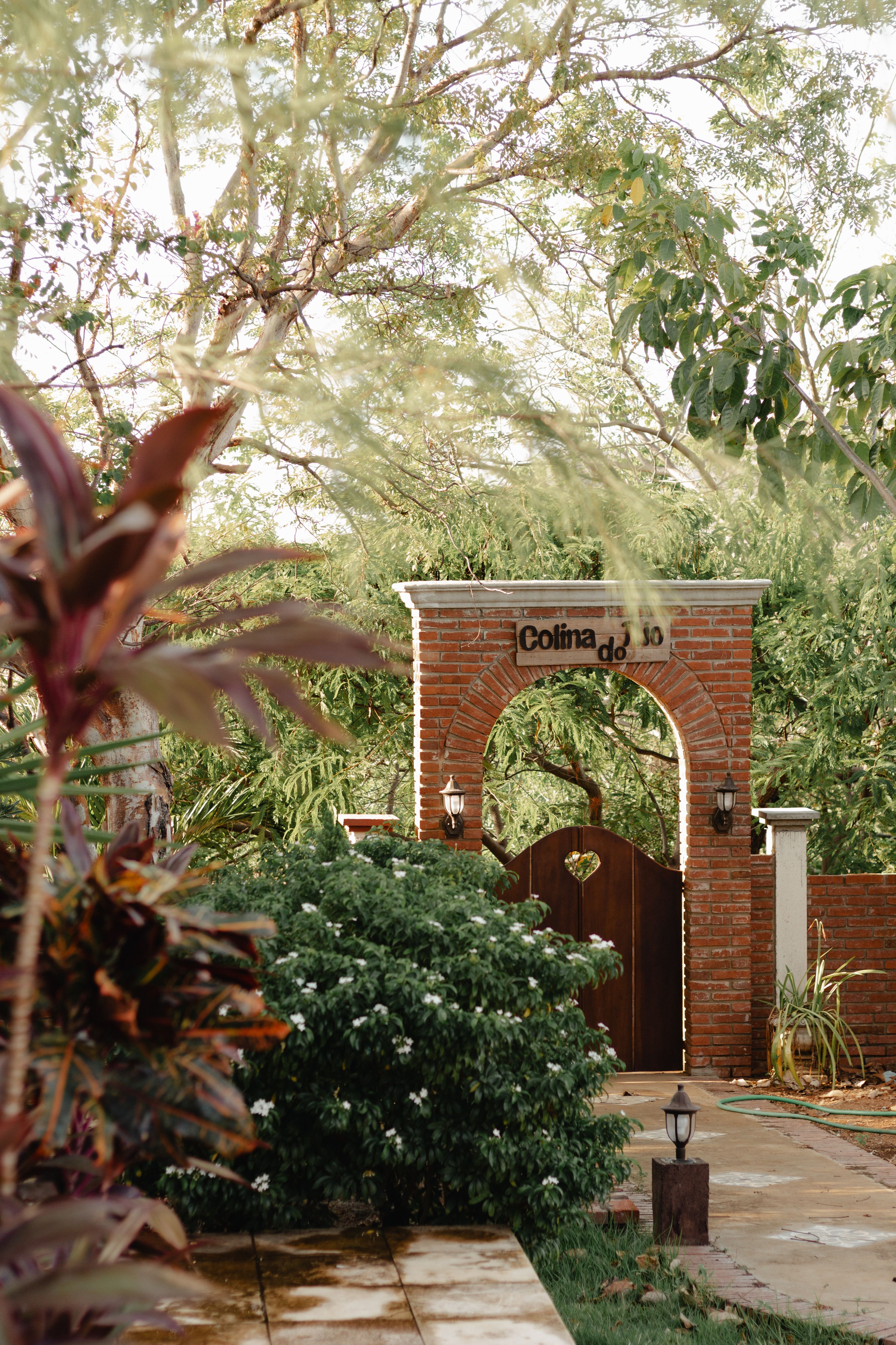 Rustic Garden Entrance with Brick Archway · Free Stock Photo