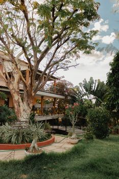 A rustic house surrounded by lush greenery and a spacious garden, ideal for countryside retreats.