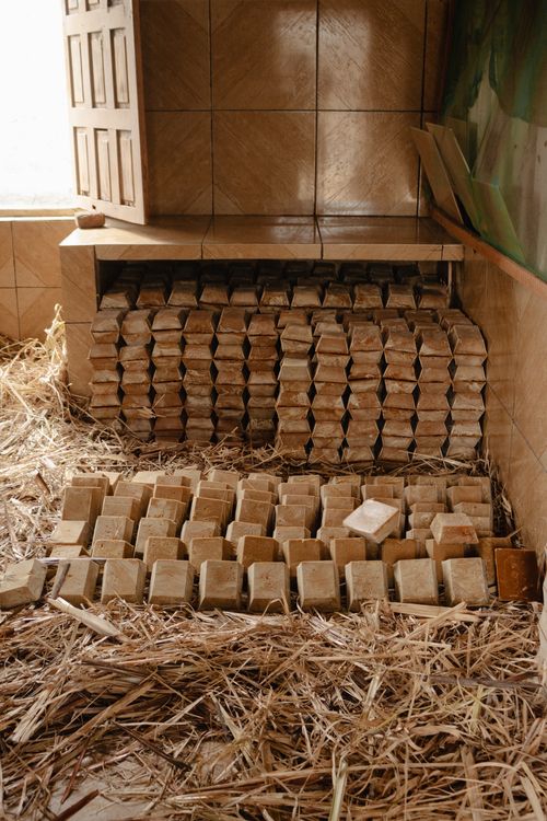 Free Artisan soap bars stacked neatly amidst straw in a rustic setting. Stock Photo