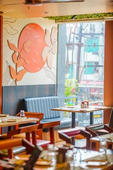 Inviting cafe interior featuring contemporary artwork, natural light, and wooden furniture.