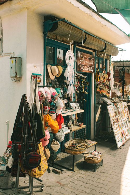 Free Colorful artisan shop facade with vibrant hats and décor items in a Mediterranean alley. Stock Photo