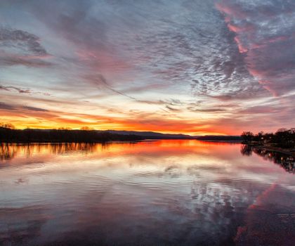 Vibrant sunset reflecting over the peaceful Mississippi River in Wabasha, Minnesota.